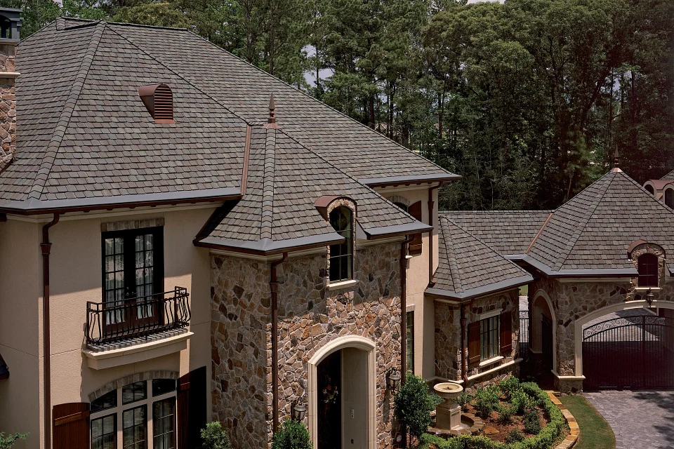 Grand Manor Luxury Roofing Shingles in Gatehouse Slate on a stone house.